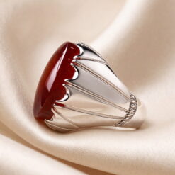 Side profile of the red Yemeni agate silver ring, showing the claw bezel and the ridged shoulders