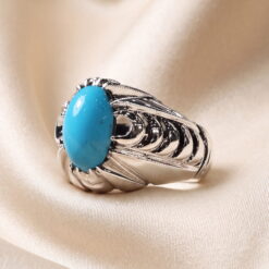 Side view of the Neyshabur turquoise silver ring, showing the fluted shoulders and the domed cabochon