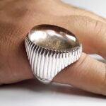 The Dur al-Najaf silver ring worn on the hand, showing its scale