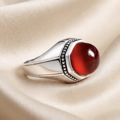 Natural red agate cabochon held in an eight-sided silver setting on a handmade 925 sterling silver ring