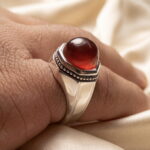 Natural red agate silver ring with an octagonal setting worn on the hand